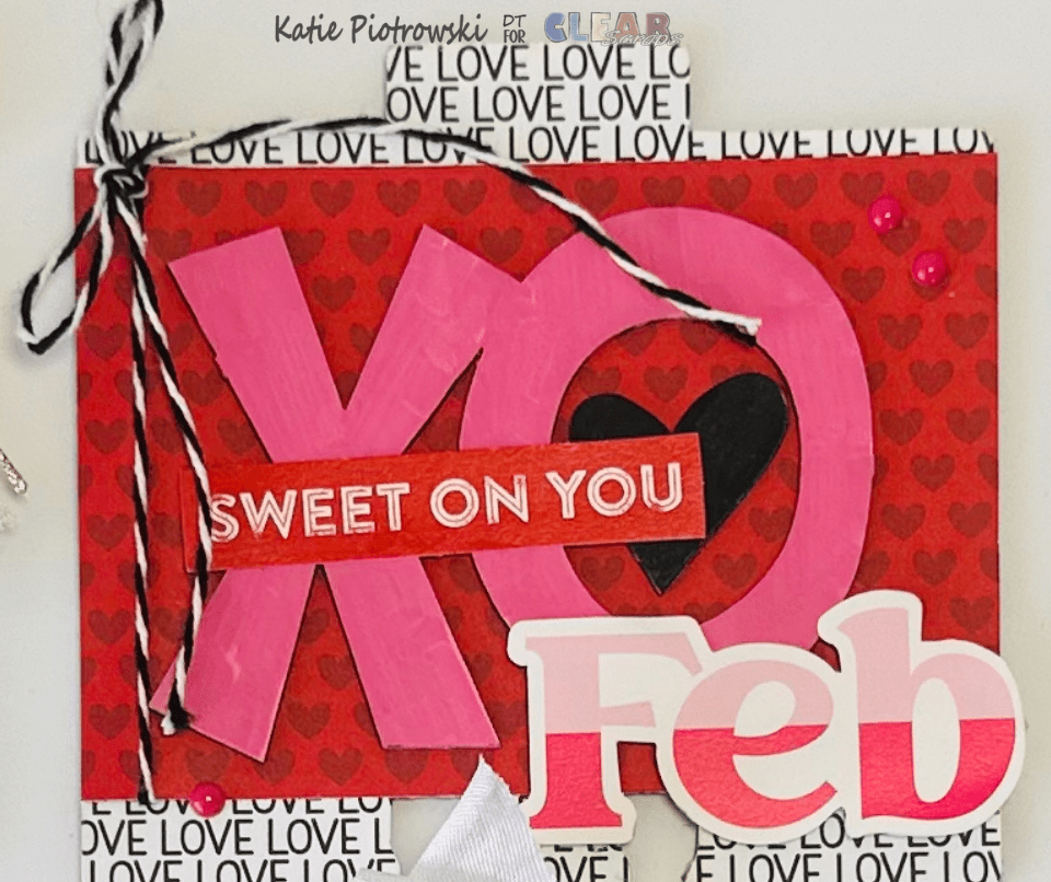 A decorative card for February featuring a large 'XO' design in pink and red colors, with the text 'SWEET ON YOU' and the month 'Feb' prominently displayed. The background includes a pattern of hearts and the word 'LOVE' repeated in black.