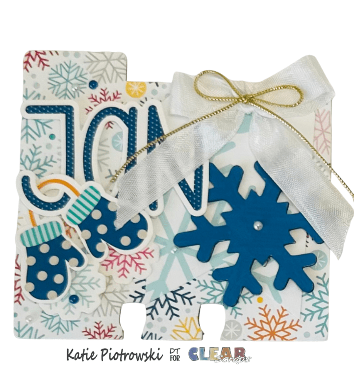 A decorative memory card for January featuring the month name in blue letters, snowflake embellishments, and mittens on a patterned background of snowflakes and pastel colors.